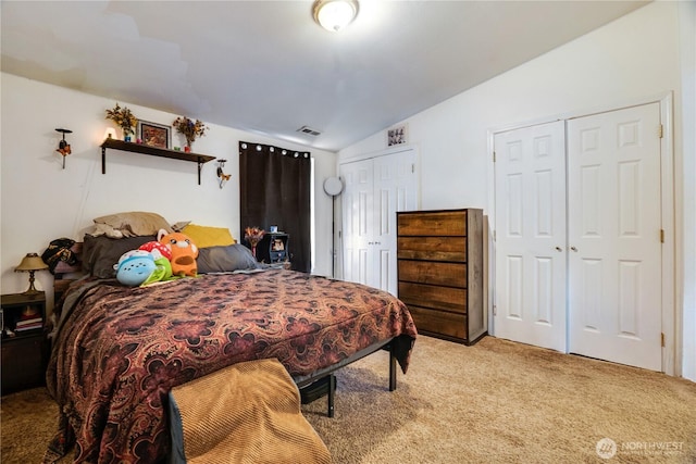 641 3rd Ave S, Kent, WA 98032 - bedroom featuring two closets, vaulted ceiling, and light carpet