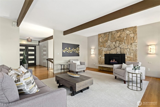 2019 Killarney Way, Bellevue, WA 98004 - living room featuring beam ceiling, wood finished floors, a stone fireplace, and baseboards