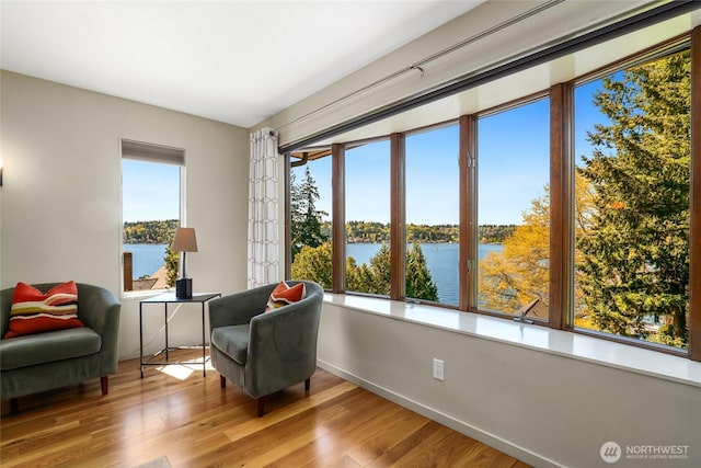 2019 Killarney Way, Bellevue, WA 98004 - living area with a water view, wood finished floors, and baseboards