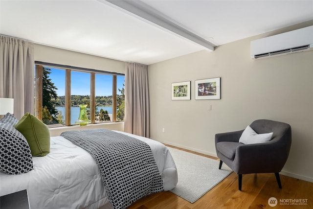 2019 Killarney Way, Bellevue, WA 98004 - bedroom featuring a wall unit AC, beam ceiling, wood finished floors, a water view, and baseboards