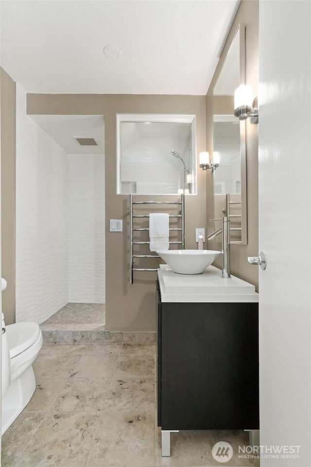 2019 Killarney Way, Bellevue, WA 98004 - bathroom with a tile shower, vanity, toilet, and a towel warming rack