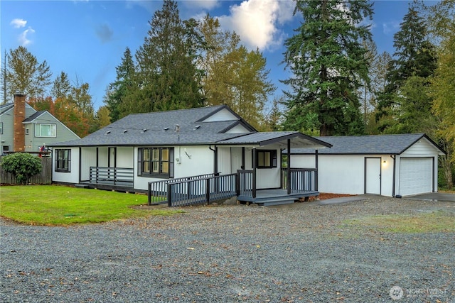11101 Bingham Ave E, Tacoma, WA 98446 - view of front facade with driveway, a front lawn, an outdoor structure, and covered porch