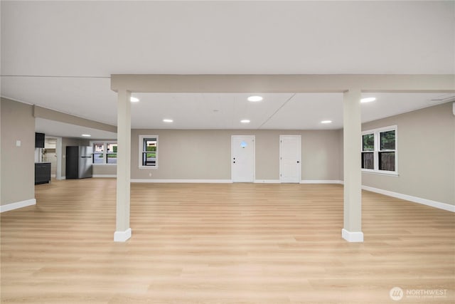 11101 Bingham Ave E, Tacoma, WA 98446 - basement featuring freestanding refrigerator, light wood-style flooring, baseboards, and recessed lighting