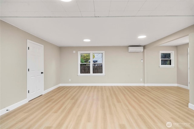 11101 Bingham Ave E, Tacoma, WA 98446 - basement with a wall mounted AC, light wood-type flooring, baseboards, and recessed lighting