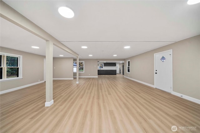 11101 Bingham Ave E, Tacoma, WA 98446 - unfurnished living room featuring baseboards, recessed lighting, and light wood-style flooring