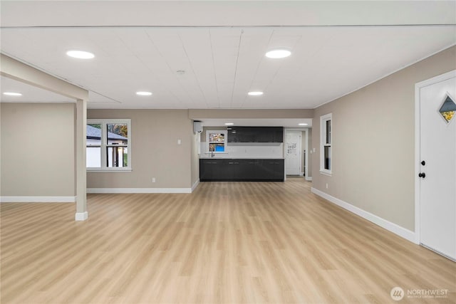 11101 Bingham Ave E, Tacoma, WA 98446 - unfurnished living room featuring light wood-style floors, baseboards, and recessed lighting