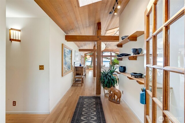 317 Eagles Roost Ln, Lopez Island, WA 98261 - hallway featuring light wood-type flooring, baseboards, wooden ceiling, a skylight, and track lighting