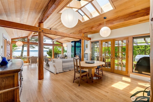 317 Eagles Roost Ln, Lopez Island, WA 98261 - dining room featuring french doors, a skylight, light wood-style floors, a water view, and wood ceiling