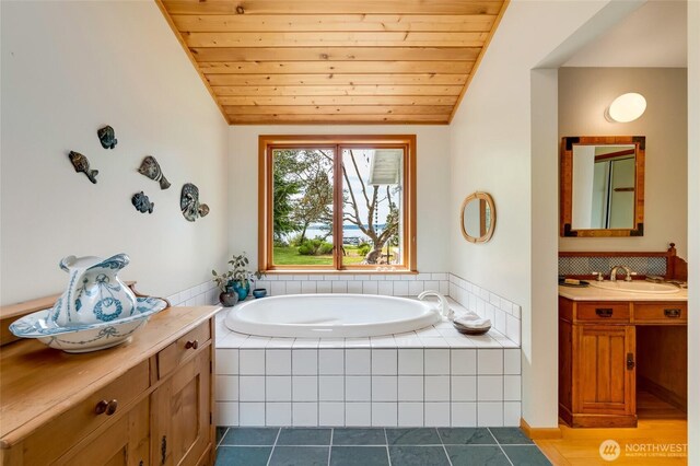 317 Eagles Roost Ln, Lopez Island, WA 98261 - full bathroom featuring vanity, lofted ceiling, wooden ceiling, a bath, and tile patterned floors