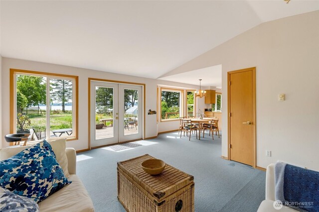 317 Eagles Roost Ln, Lopez Island, WA 98261 - living area with vaulted ceiling, french doors, a chandelier, plenty of natural light, and carpet