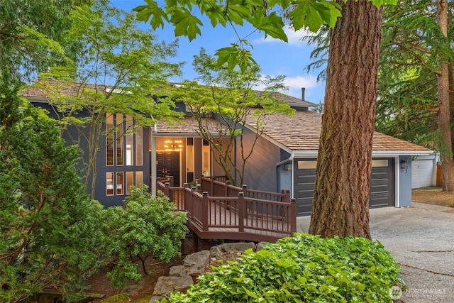 16822 SE 26th St, Bellevue, WA 98008 - view of front of property with driveway, a deck, a chimney, and stucco siding