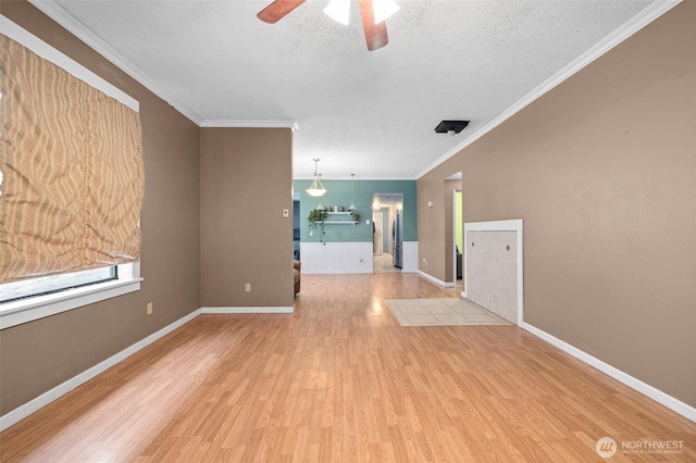 3710 Rucker Ave, Everett, WA 98201 - unfurnished living room with ceiling fan, wood finished floors, a textured ceiling, crown molding, and baseboards
