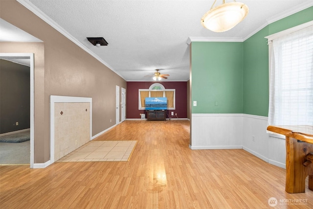 3710 Rucker Ave, Everett, WA 98201 - unfurnished dining area with wood finished floors, a ceiling fan, crown molding, and a wainscoted wall