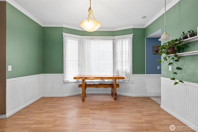 3710 Rucker Ave, Everett, WA 98201 - dining area with a textured ceiling, wood finished floors, healthy amount of natural light, a wainscoted wall, and crown molding