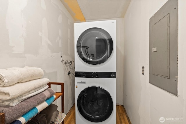 3710 Rucker Ave, Everett, WA 98201 - laundry room with stacked washing machine and dryer, electric panel, and wood finished floors