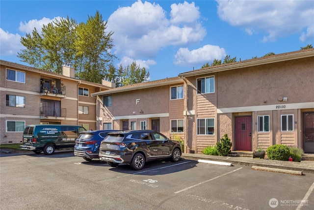 20110 60th Ave W Unit F26, Lynnwood, WA 98036 - view of building exterior with uncovered parking