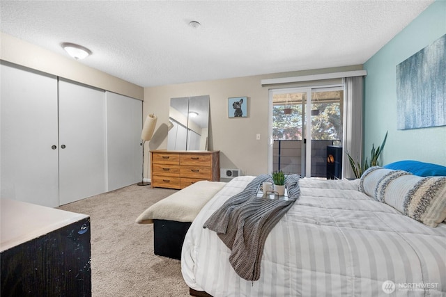 20110 60th Ave W Unit F26, Lynnwood, WA 98036 - bedroom with carpet, access to outside, a textured ceiling, and a closet