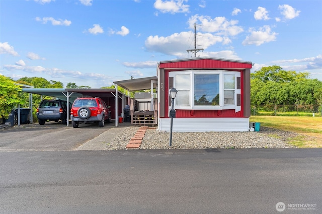 260 Ho Hum Ln, Aberdeen, WA 98520 - manufactured / mobile home featuring asphalt driveway and a carport