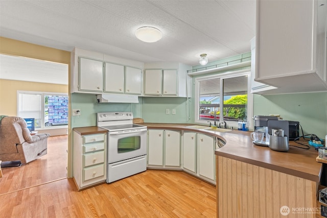260 Ho Hum Ln, Aberdeen, WA 98520 - kitchen featuring white range with electric stovetop, under cabinet range hood, light wood-style floors, plenty of natural light, and a textured ceiling
