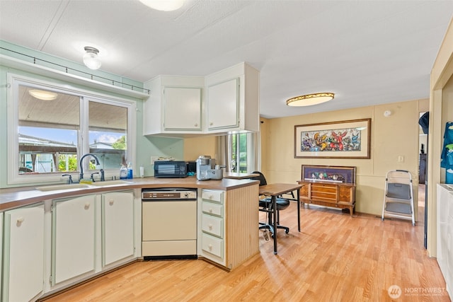 260 Ho Hum Ln, Aberdeen, WA 98520 - kitchen featuring dishwasher, light countertops, light wood-type flooring, and healthy amount of natural light