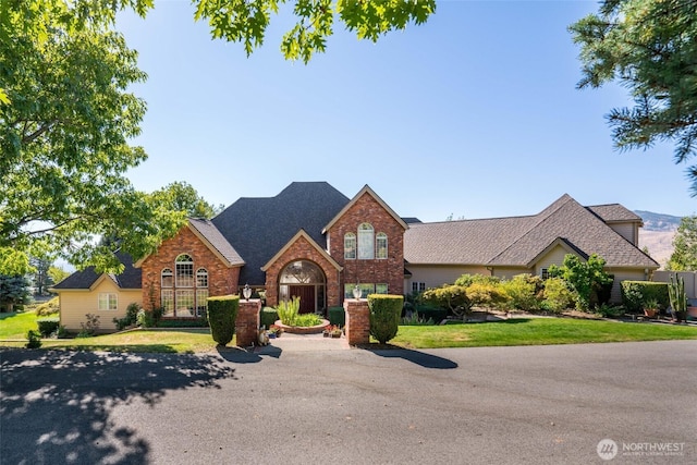 4180 April Dr, Wenatchee, WA 98801 - traditional-style house featuring brick siding and roof with shingles