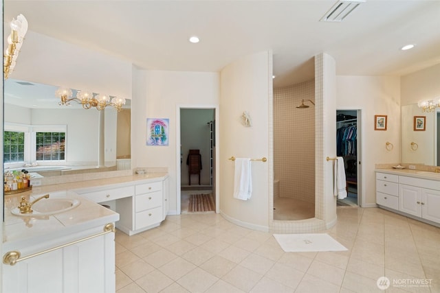 4180 April Dr, Wenatchee, WA 98801 - bathroom featuring a chandelier, two vanities, tile patterned floors, tiled shower, and recessed lighting