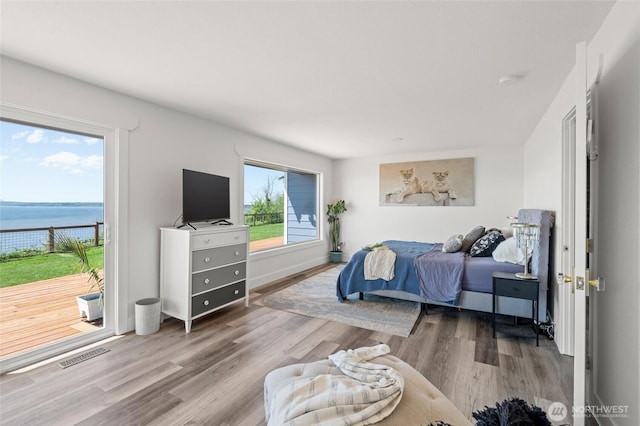 3161 Locust Ave, Bellingham, WA 98225 - bedroom featuring a water view, wood finished floors, and access to exterior