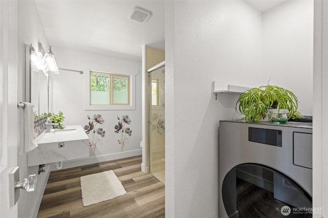3161 Locust Ave, Bellingham, WA 98225 - full bathroom with a stall shower, wood finished floors, toilet, and baseboards