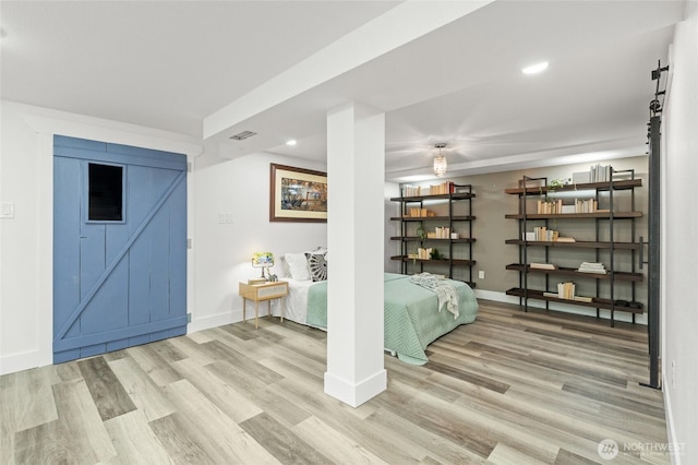 3161 Locust Ave, Bellingham, WA 98225 - bedroom featuring a barn door, wood finished floors, baseboards, and recessed lighting