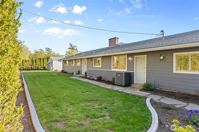 3161 Locust Ave, Bellingham, WA 98225 - back of property featuring central air condition unit, a chimney, an outdoor structure, and brick siding