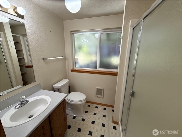 4882 Laura Ln SE, Port Orchard, WA 98367 - full bathroom with heating unit, a stall shower, vanity, toilet, and a textured ceiling