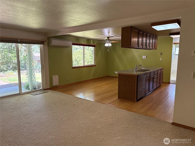 4882 Laura Ln SE, Port Orchard, WA 98367 - kitchen with a sink, a wall mounted AC, light wood-type flooring, dishwasher, and ceiling fan
