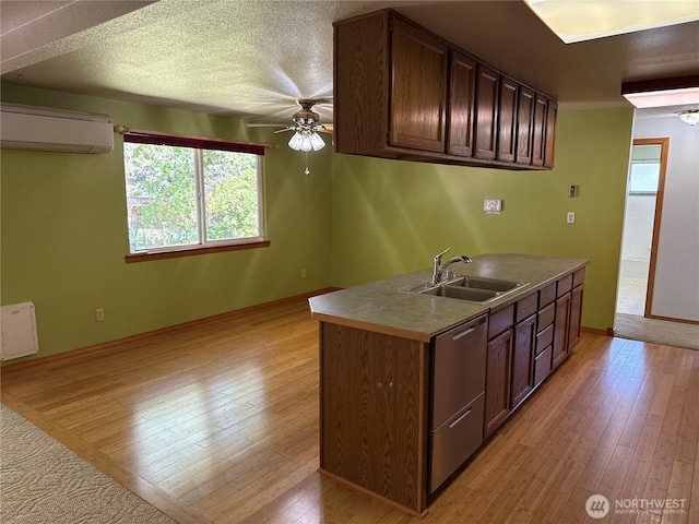 4882 Laura Ln SE, Port Orchard, WA 98367 - kitchen with dishwasher, an AC wall unit, a sink, a ceiling fan, and light wood-style floors