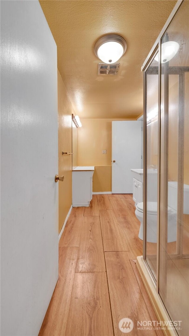 29604 22nd S, Federal Way, WA 98003 - hall featuring light wood finished floors, baseboards, and a textured ceiling