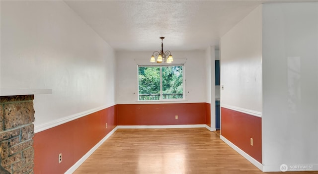 29604 22nd S, Federal Way, WA 98003 - unfurnished dining area featuring light wood-type flooring, a chandelier, baseboards, and a textured ceiling