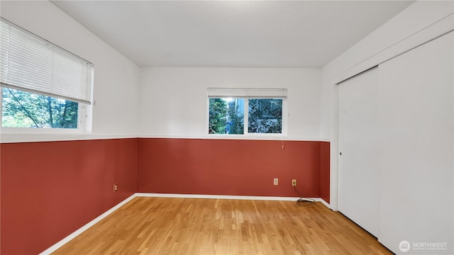 29604 22nd S, Federal Way, WA 98003 - unfurnished bedroom with multiple windows, light wood-style floors, baseboards, and a closet