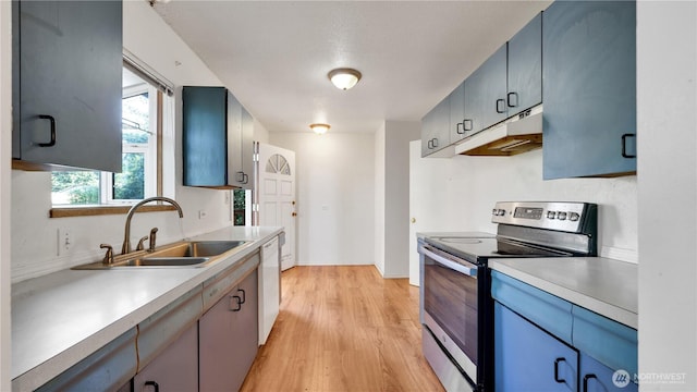 29604 22nd S, Federal Way, WA 98003 - kitchen with electric range, under cabinet range hood, a sink, light countertops, and light wood-type flooring