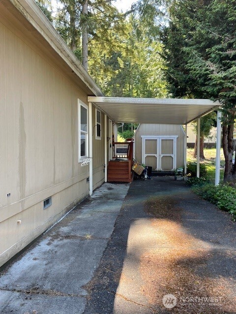 11410 127th St E Unit 185, Puyallup, WA 98374 - view of car parking with a storage shed and a carport