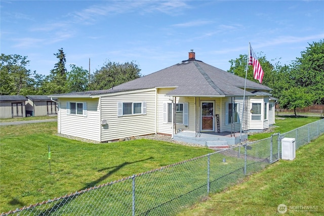 108 2nd St SE, Rainier, WA 98576 - rear view of house featuring a chimney, roof with shingles, and an outdoor structure