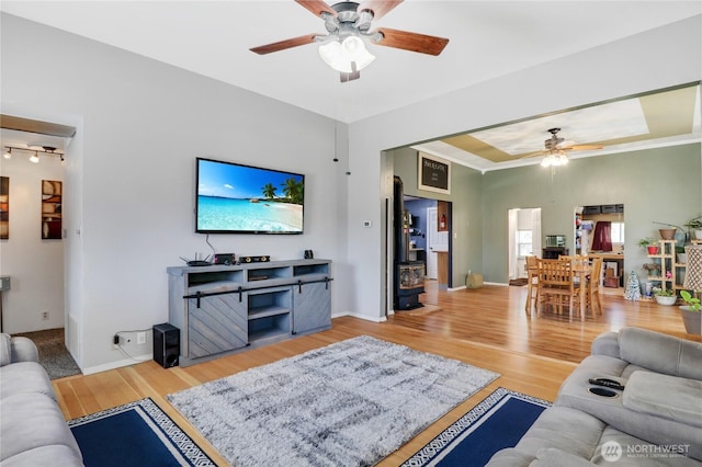 108 2nd St SE, Rainier, WA 98576 - living room with a ceiling fan, wood finished floors, and baseboards