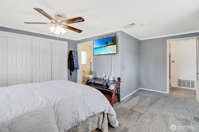 108 2nd St SE, Rainier, WA 98576 - carpeted bedroom with baseboards, a closet, crown molding, ceiling fan, and ensuite bathroom