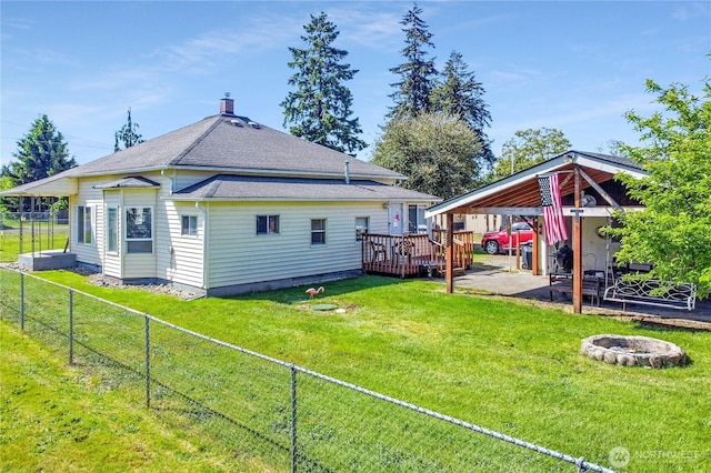 108 2nd St SE, Rainier, WA 98576 - rear view of house with a deck, a fire pit, roof with shingles, a patio, and a chimney