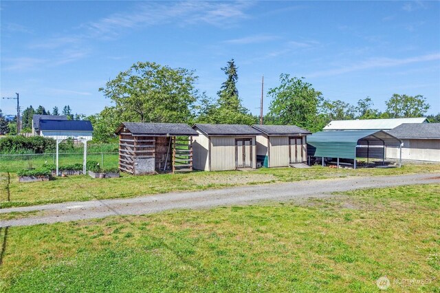 108 2nd St SE, Rainier, WA 98576 - view of outdoor structure with driveway and a detached carport