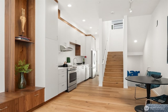 633 13th Ave E, Seattle, WA 98102 - kitchen featuring stainless steel electric stove, freestanding refrigerator, ventilation hood, dishwasher, and white cabinets