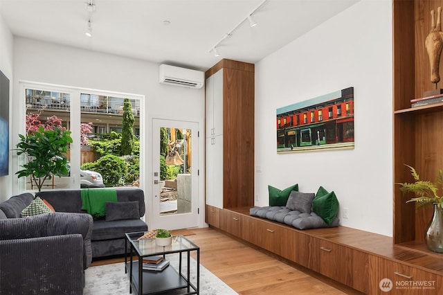 633 13th Ave E, Seattle, WA 98102 - living area featuring rail lighting, a wall unit AC, and light wood-type flooring