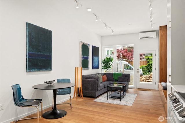 633 13th Ave E, Seattle, WA 98102 - living room featuring an AC wall unit, rail lighting, and light wood-style floors
