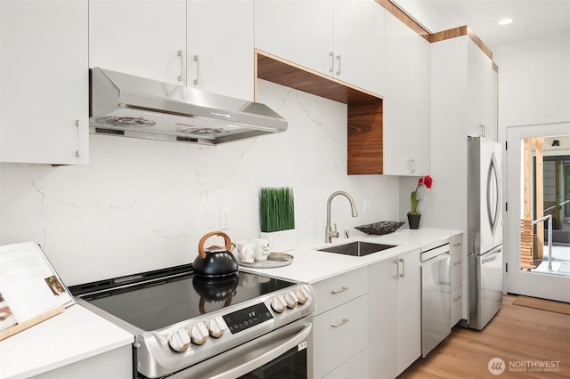 633 13th Ave E, Seattle, WA 98102 - kitchen featuring stainless steel range with electric cooktop, under cabinet range hood, freestanding refrigerator, a sink, and dishwasher