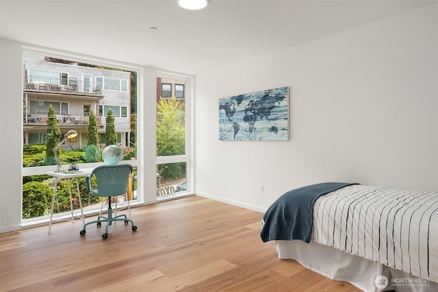 633 13th Ave E, Seattle, WA 98102 - bedroom featuring baseboards and wood finished floors