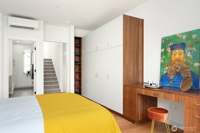 633 13th Ave E, Seattle, WA 98102 - bedroom with a wall mounted air conditioner, light wood finished floors, and a closet
