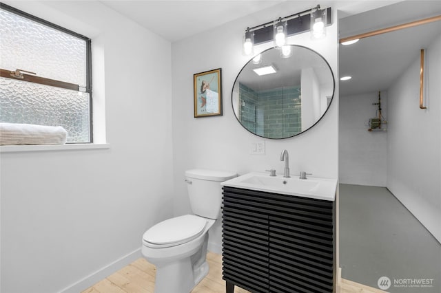 406 Center Pl, Everett, WA 98203 - full bathroom with toilet, vanity, wood finished floors, and baseboards